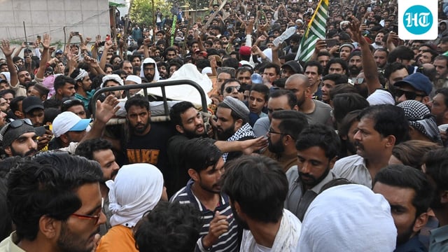 Awami Action Committee (AAC) activists gather around the coffin of a protester who was allegedly killed by police personnel, during a demonstration in Muzaffarabad, capital of Pakistan-occupied Kashmir 