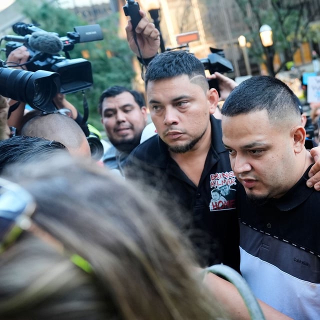 Kilmar Abrego Garcia, right, and his brother Cesar Abrego Garcia, center, arrive at the Immigration and Customs Enforcement field office in Baltimore, Monday, Aug. 25, 2025. (AP Photo/Stephanie Scarbrough)