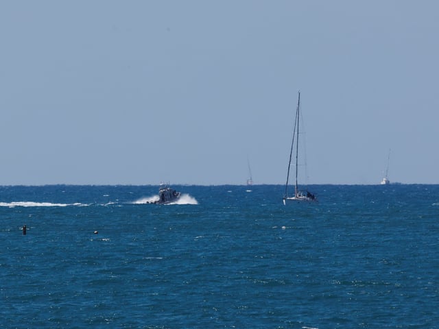 An Israeli navy vessel escorts a vessel from the Global Sumud Flotilla to Ashdod Port, after Israel intercepted some of the vessels of the Flotilla aiming to reach Gaza and break Israel's naval blockade, in southern Israel, October 2, 2025. REUTERS/Ammar Awad