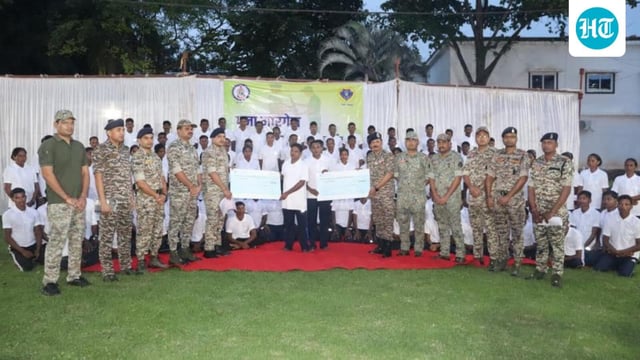 The mass surrender took place in the presence of senior police and paramilitary officers.