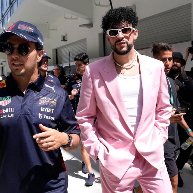 FILE - Red Bull driver Sergio Perez, of Mexico, left, walks with Puerto Rican reggaeton musician Bad Bunny before a Formula One Miami Grand Prix auto race at Miami International Autodrome in Miami Gardens, Fla., on  May 8, 2022. As the sport grows in popularity, race weekends are transforming into mini music festivals with A-list talent performing after the day's event. (AP Photo/Lynne Sladky, File)