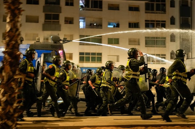Security forces disperse a gathering as youth led protests calling for healthcare and education reforms turned violent, in Sale, Morocco, Wednesday, Oct. 1, 2025. (AP Photo/Mosa'ab Elshamy)