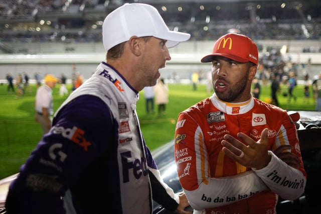 DAYTONA BEACH, FLORIDA - FEBRUARY 16: Bubba Wallace, driver of the #23 McDonald's Toyota, (R) speaks with Denny Hamlin, driver of the #11 FedEx 50 Toyota, on the grid prior to the NASCAR Cup Series Bluegreen Vacations Duel #1 at Daytona International Speedway on February 16, 2023 in Daytona Beach, Florida. (Photo by Chris Graythen/Getty Images)