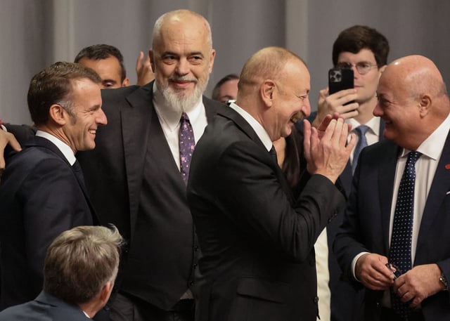 (L-R) France's President Emmanuel Macron, Albania's Prime Minister Edi Rama, Azerbaijan's President Ilham Aliyev and Austria's Chancellor Christian Stocker share a laugh during a working session of the 7th European Political Community (EPC) Summit at the Bella Center in Copenhagen on October 2, 2025.