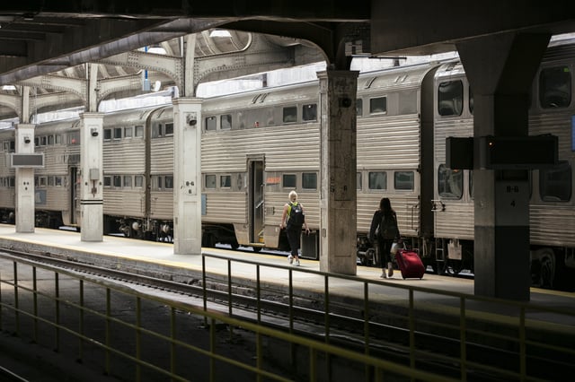 Commuters board a Metra train at Union Station in Chicago, Illinois, US, on Thursday, Sept. 15, 2022. President Joe Biden hailed a tentative railway labor agreement he helped to broker that averted an economically perilous nationwide work stoppage less than two months ahead of the November midterm elections. Photographer: Jim Vondruska/Bloomberg via Getty Images