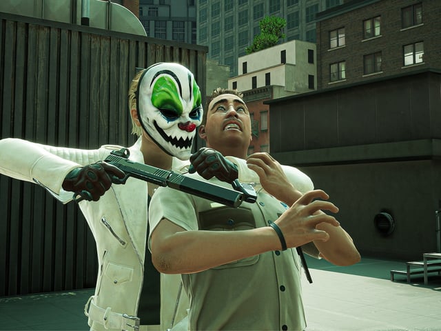 Payday 3 screenshot where a masked character holds a person hostage
