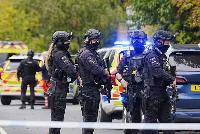 Armed officers line up after a deadly attack outside a synagogue in Manchester, northern England. British lawmakers have announced increased police presence near Jewish places of worship.