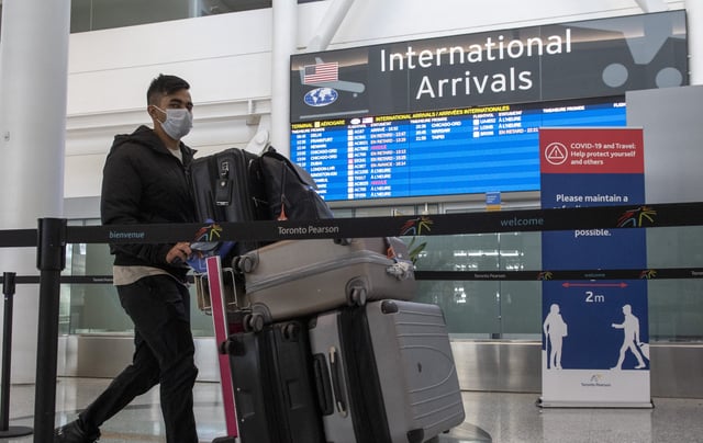 A passenger from Air India flight 187 from New Delhi arrives at Pearson Airport in Toronto on Wednesday April 21, 2021. THE CANADIAN PRESS/Frank Gunn