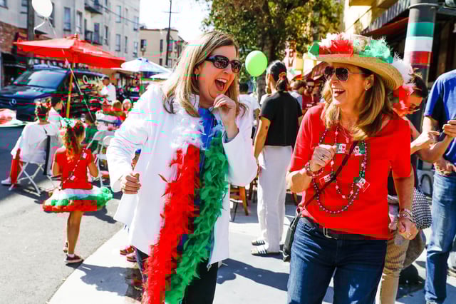Elaine Cosca and Angela Mullin dance in the street during the 151st Italian Heritage Parade in North Beach in San Francisco in 2019.