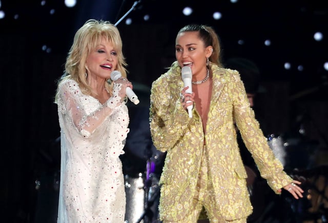 Dolly Parton, left, and Miley Cyrus perform "Jolene" at the 61st annual Grammy Awards in Los Angeles on Feb. 10, 2019. Administrators at Heyer Elementary School in Waukesha, Wis., aren't letting a first-grade class perform "Rainbowland," a Cyrus and Parton duet from Cyrus' 2017 album "Younger Now," promoting LGBTQ acceptance, because they say the song could be seen as controversial. Matt Sayles/Invision/AP