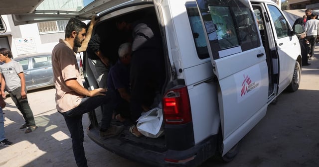 Palestinians transport the body of a member of the Doctors Without Borders NGO, who was killed in Israeli strikes in Deir Al Balah. AFP