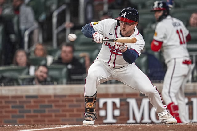 Apr 9, 2025; Cumberland, Georgia, USA; Atlanta Braves outfielder Jarred Kelenic (24) tries to sacrifice bunt against the Philadelphia Phillies during the eighth inning at Truist Park. Mandatory Credit: Dale Zanine-Imagn Images/ File Photo
