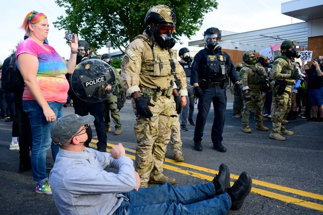 PORTLAND, OREGON - SEPTEMBER 28: Federal agents confront protesters outside of the U.S. Immigration and Customs Enforcement building on September 28, 2025 in Portland, Oregon. In a Truth Social post on September 27th, President Trump authorized the deployment of military troops to "protect War ravaged Portland, and any of our ICE Facilities under siege from attack by Antifa, and other domestic terrorists." (Photo by Mathieu Lewis-Rolland/Getty Images)