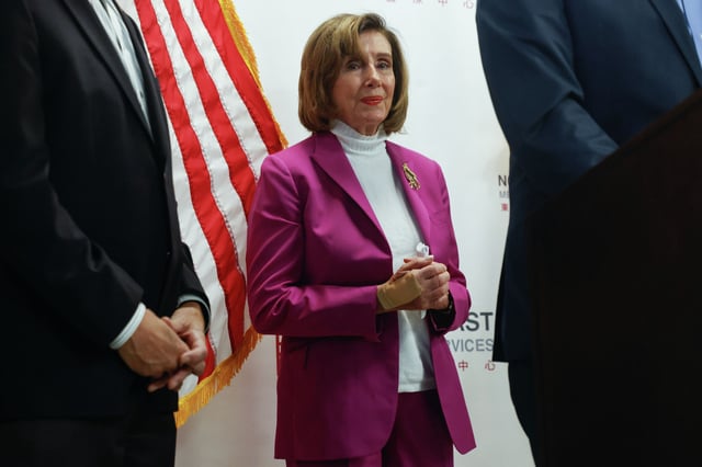 Speaker Emerita Nancy Pelosi, center, listens as Rep. Kevin Mullin, right, speaks at a press conference at North East Medical Services about the government shutdown on Oct. 2, 2025 in San Francisco.