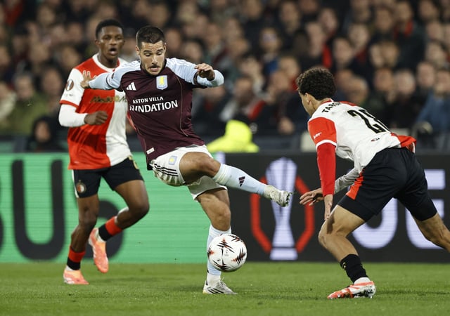Soccer Football - UEFA Europa League - Feyenoord v Aston Villa - Feyenoord Stadium, Rotterdam, Netherlands - October 2, 2025 Aston Villa's Emiliano Buendia in action with Feyenoord's Oussama Targhalline REUTERS/Maurice Van Steen