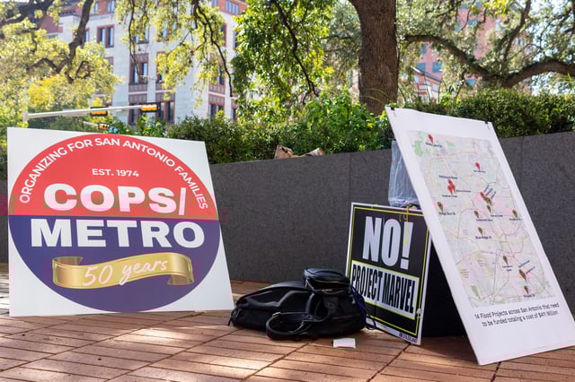 COPS/Metro Alliance signs sit at City Hall after a press conference on Oct. 2, 2025. The group is urging voters to reject Proposition B.