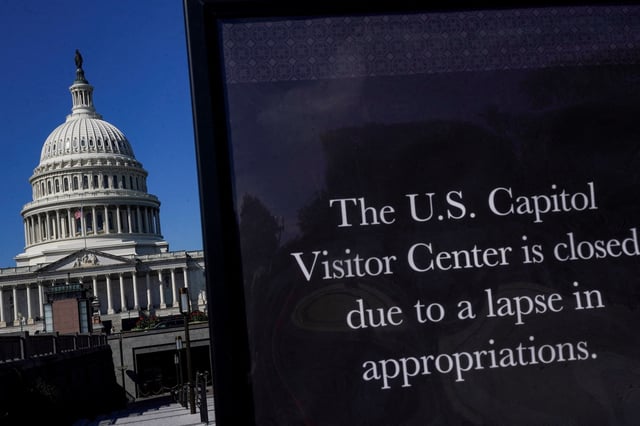 A view of a sign warning that the U.S. Capitol Visitor Center is closed, with the U.S. Capitol dome visible in the background, on the first day of a partial government shutdown, in Washington, D.C., U.S., October 1, 2025. REUTERS/Nathan Howard/File Photo