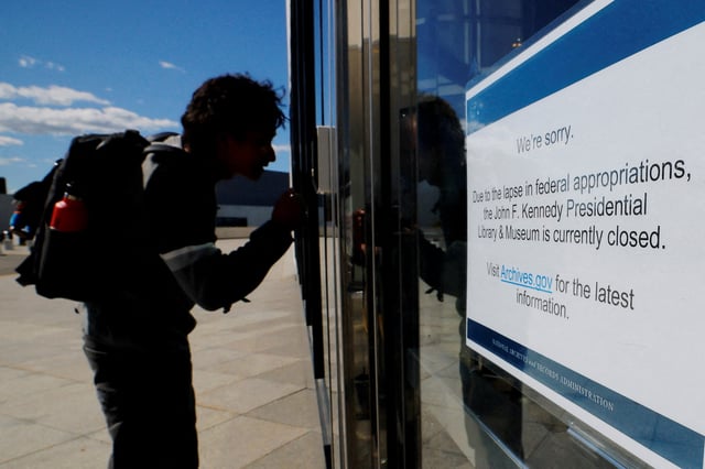 A would-be visitor looks into the John F. Kennedy Presidential Library and Museum which is closed, on the first day of a partial U.S. government shutdown, in Boston, Massachusetts, U.S., October 1, 2025.   REUTERS/Brian Snyder/File Photo
