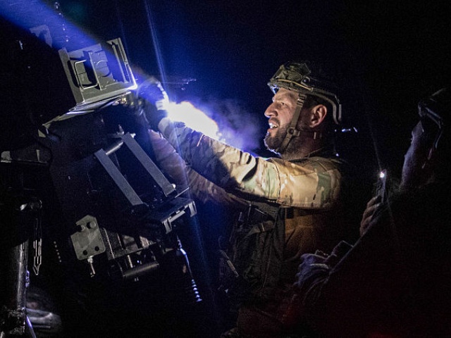 CHERNOBYL, UKRAINE - AUGUST 28: Rifleman (machine gunner's assistant) Daniiil Serhiiovych Nabatov, call sign "Nabat," adjusts the machine gun in the Chornobyl Exclusion Zone on August 28, 2025 in Chernobyl, Ukraine. (Photo by Danylo Dubchak Frontliner/Getty Images)