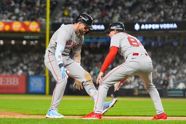 Boston Red Sox Trevor Story (10) celebrates with third base coach Kyle Hudson (84) as he rounds the bases after hitting a solo home run against the New York Yankees during the sixth inning of Game 2 of an American League wild-card baseball playoff series, Wednesday, Oct. 1, 2025, in New York. (AP Photo/Yuki Iwamura)