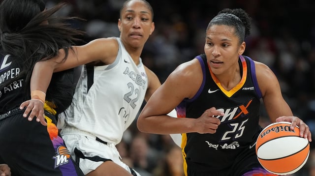 Aug 15, 2025; Phoenix, Arizona, USA; Phoenix Mercury forward Alyssa Thomas (25) drives around Las Vegas Aces center A'ja Wilson (22) in the second half at Footprint Center. Mandatory Credit: Rick Scuteri-Imagn Images