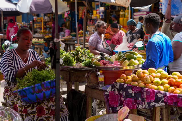 FILE - A vegetable seller sorts fresh produce at a market in Conakry, Guinea, Sept. 19, 2025 (AP Photo/Misper Apawu, File)