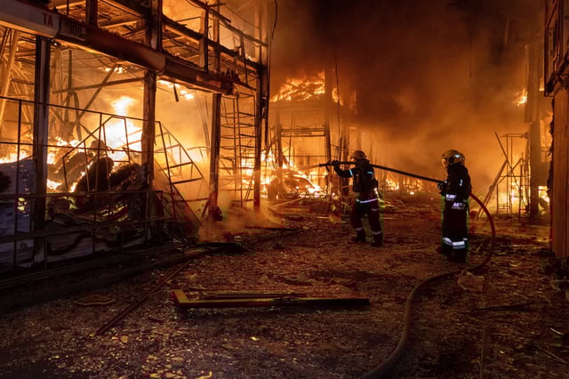 Firefighters tackle the blaze after a Russian air attack that hit at Barabashovo market in Kharkiv, Ukraine, on Oct. 1, 2025.