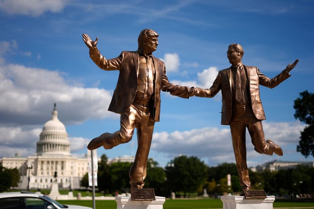 People take photos of a protest art representing President Donald Trump and Jeffrey Epstein on the National Mall near the U.S. Capitol, on Oct. 2, 2025.