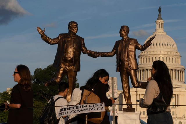 A statue on the National Mall, depicting President Donald Trump and Jeffrey Epstein, top right, holding hands is seen at sundown on the National Mall Thursday, Oct. 2, 2025, in Washington. (AP Photo/Manuel Balce Ceneta)
