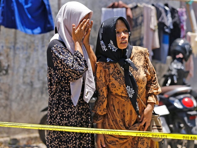 Family of students react while waiting for news as the rescue operations continue following a building collapse on Monday, where people remained trapped according to disaster mitigation agency, at Al Khoziny Islamic boarding school in Sidoarjo, East Java province, Indonesia, October 2, 2025. REUTERS/Dipta Wahyu