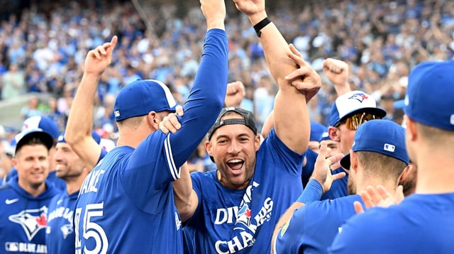 Sep 28, 2025; Toronto, Ontario, CAN; Toronto Blue Jays designated hitter George Springer (4) celebrates with teammates after a win over the Tampa Bay Rays clinched first place in the American League East Division at Rogers Centre. Mandatory Credit: Dan Hamilton-Imagn Images