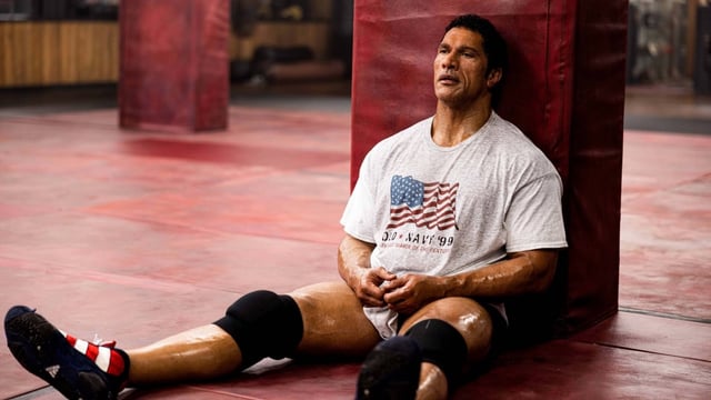 Dwane (The Rock) Johnson appears as Mark Kerr in a still from The Smashing Machine. The fighting biopic gestures at greatness, without ever reaching it.