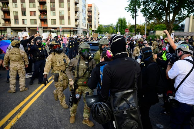 Federal agents confront protesters outside of the U.S. Immigration and Customs Enforcement building on September 28, 2025 in Portland, Oregon.