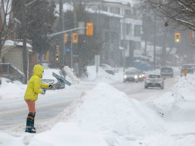 Ottawa resident cleaning up during a snow storm.
