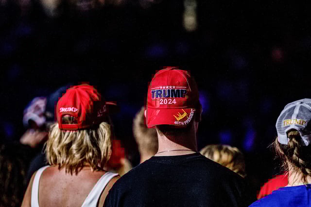 Attendees wearing Trump hats prior to a town hall event with Donald Trump in Flint, Mich., on Sept. 17, 2024.