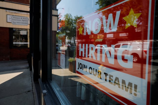 A "Now Hiring" sign hangs in the window of a hair salon in the Greater Boston town of Medford, Massachusetts, U.S., August 12, 2025.   REUTERS/Brian Snyder