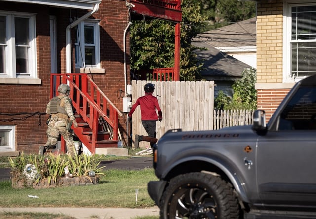 A U.S. Immigration and Customs Enforcement agent chases a protester into a residential yard near the ICE holding facility in Broadview on Sept. 26, 2025. (E. Jason Wambsgans/Chicago Tribune)