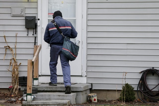 A postal worker delivers mail in the Edgelea neighborhood of Lafayette, Wednesday, Jan. 19, 2022
