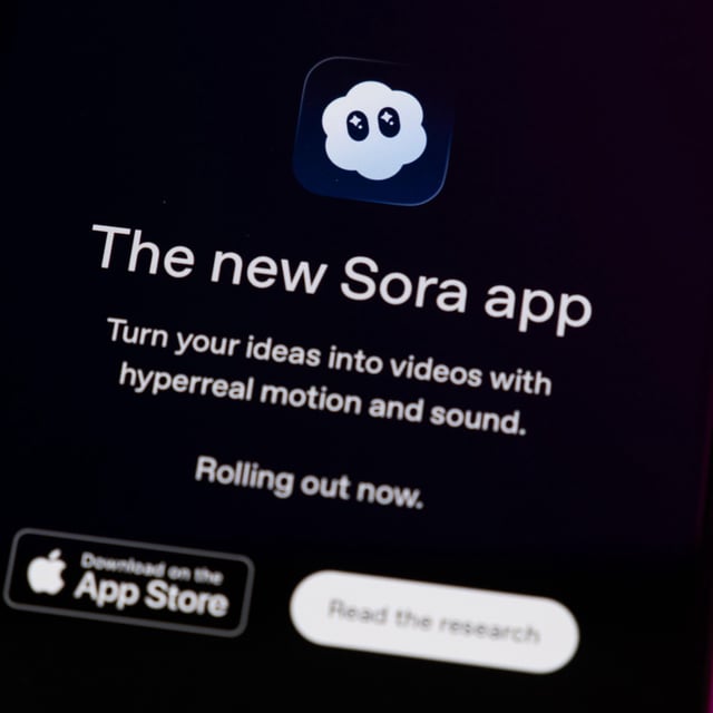 The Sora App home page displays on a smartphone screen placed on a computer keyboard illuminated by blue and purple light.