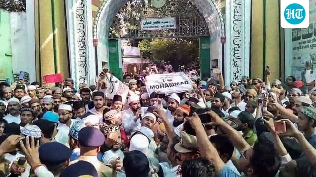 People holding a banner reading 'I love Mohammad' stage a protest outside Naumahal Mosque after the Friday prayers over the 'I love Mohammad' row, in Bareilly