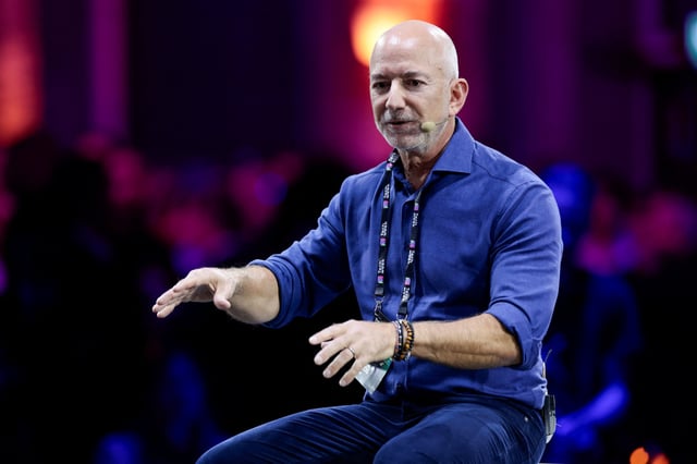 Amazon founder Jeff Bezos gestures as he speaks at the main panel of Italian Tech Week 2025 in Turin, Italy October 3, 2025. REUTERS/Remo Casilli