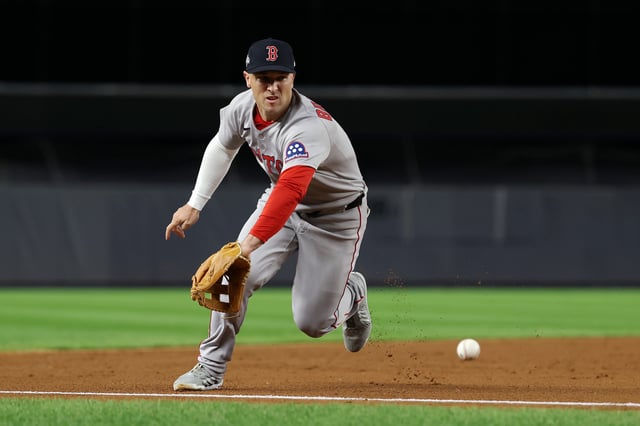 NEW YORK, NEW YORK - OCTOBER 02: Alex Bregman #2 of the Boston Red Sox attempts to field a ground ball during the second inning against the New York Yankees in game three of the American League Wild Card Series at Yankee Stadium on October 02, 2025 in the Bronx borough of New York City. (Photo by Al Bello/Getty Images)