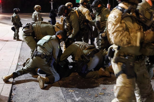U.S. Border Patrol Agents detain a demonstrator during a protest outside of the Immigration and Customs Enforcement headquarters in south Portland, Oregon, on Oct. 3, 2025.