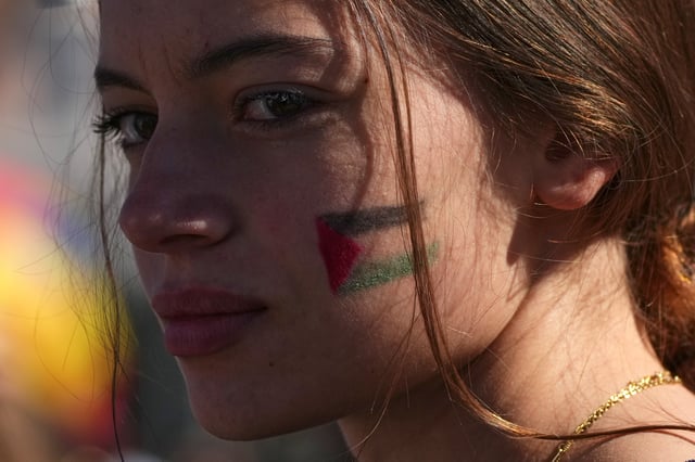 A pro-Palestinian demonstrator gathers for a national general strike called by different unions to protest against the situation in Gaza two days after Israeli forces intercepted a Gaza-bound aid flotilla in the Mediterranean Sea, in Rome, Friday, Oct. 3, 2025. (AP Photo/Alessandra Tarantino)