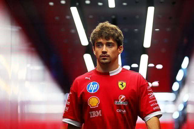 SINGAPORE, SINGAPORE - OCTOBER 02: Charles Leclerc of Monaco and Scuderia Ferrari walks in the garage during previews ahead of the F1 Grand Prix of Singapore at Marina Bay Street Circuit on October 02, 2025 in Singapore, Singapore. (Photo by Clive Mason/Getty Images)