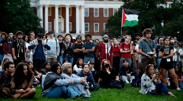 Attendees listen as names of Palestinian infants killed in the war in Gaza are read aloud during a vigil organized by the Students for Justice in Palestine at the University of Maryland campus on October 07, 2024 in College Park, Maryland. (Chip Somodevilla/Getty Images)