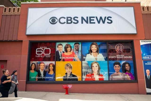 FILE – People walk by the CBS Broadcast Center on 57th Street in New York on April 20, 2023. CBS News has asked all of its local stations to become proficient in “solutions journalism,” a story-telling method that has taken off in the past decade to counter people who think reporters are obsessed with bad news. (AP Photo/Ted Shaffrey, File)