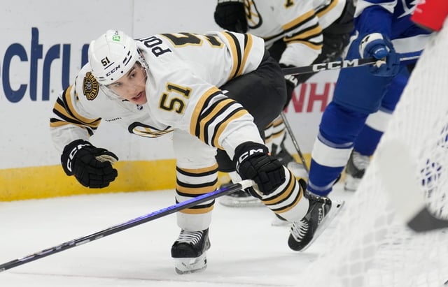 Boston Bruins center Matt Poitras battles for the puck against the Tampa Bay Lightning on Nov. 24, 2023. (AP Photo/Chris O'Meara)