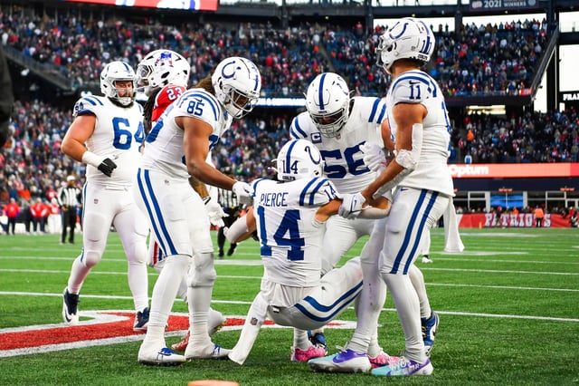 FOXBOROUGH, MASSACHUSETTS - DECEMBER 01: Members of the Indianapolis Colts embrace Alec Pierce #14 of the Indianapolis Colts after scoring a touchdown during the second half against the New England Patriots at Gillette Stadium on December 01, 2024 in Foxborough, Massachusetts. (Photo by Jaiden Tripi/Getty Images)