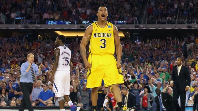 Mar 29, 2013; Arlington, TX, USA; Michigan Wolverines guard Trey Burke (3) reacts after hitting a three-point shot to tie the game with six seconds against the Kansas Jayhawks in the second half during the semifinals of the South regional of the 2013 NCAA Tournament at Cowboys Stadium. Mandatory Credit: Kevin Jairaj-Imagn Images